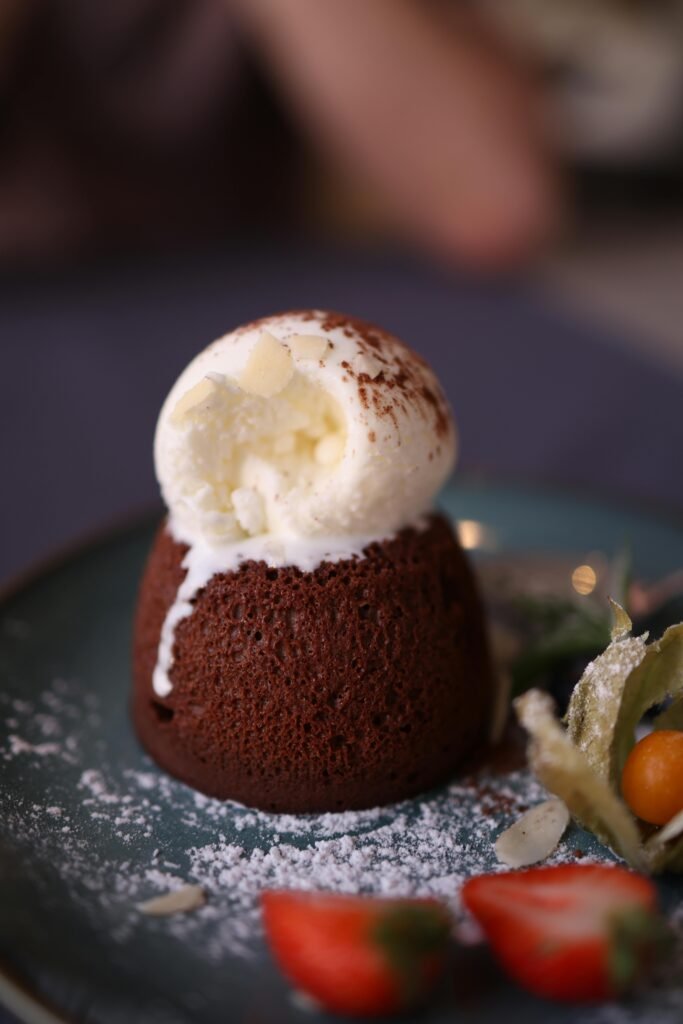 Rich chocolate lava cake topped with vanilla ice cream, perfect dessert indulgence. molten chocolate lava cake chili's