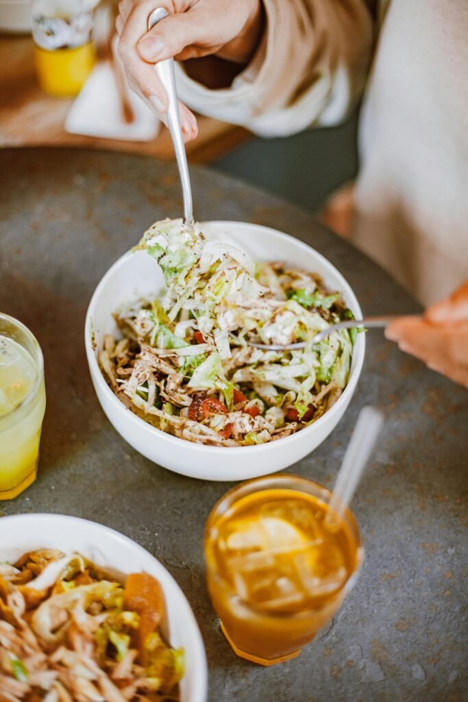 Close-up of a healthy chicken salad bowl with iced tea and lemonade on a table, perfect for dieting. Classic Chicken Salad Recipe