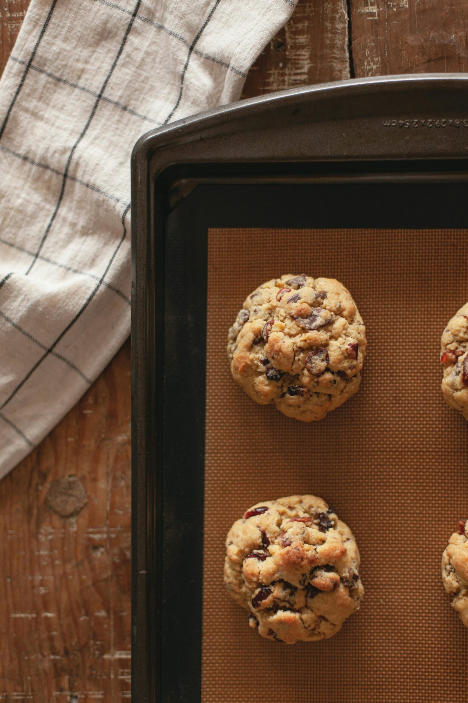 Top view of freshly baked cookies on a tray, showcasing delicious homemade confectionery.