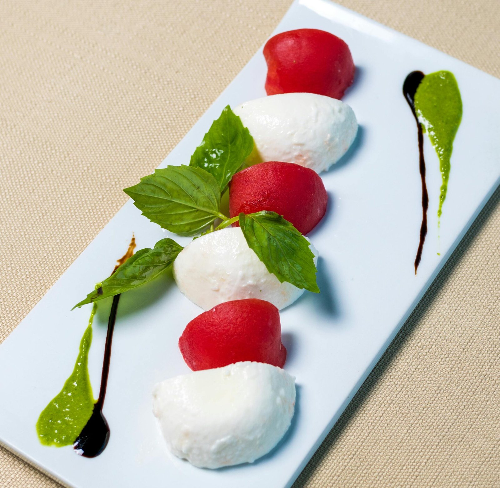 Elegant Caprese salad featuring fresh mozzarella, tomato, basil, and balsamic drizzle.