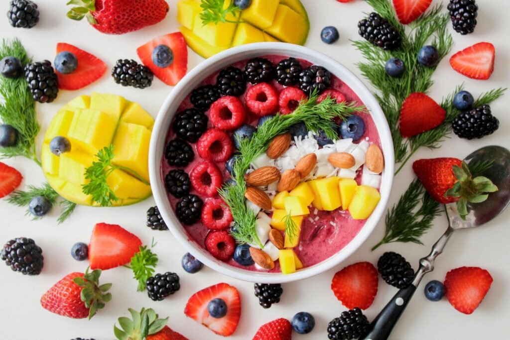 pexels-photo-1099680-1099680 A vibrant, healthy fruit smoothie bowl topped with fresh berries, mango, and almonds.