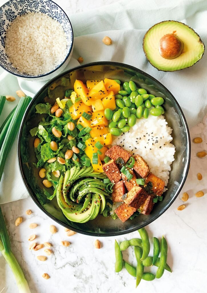 A vibrant vegan Buddha bowl with rice, avocado, tofu, and vegetables. chipotle burrito bowl recipe