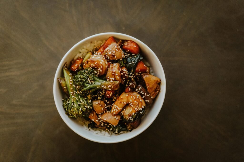 Top view of a bowl with stir-fried vegetables and sesame seeds, perfect for healthy eating visuals. teriyaki stir fry vegetables recipe