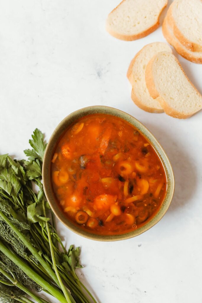 Top view of a hearty Russian solyanka soup with fresh bread slices, capturing a taste of traditional cuisine. Lasagna Soup Recipe